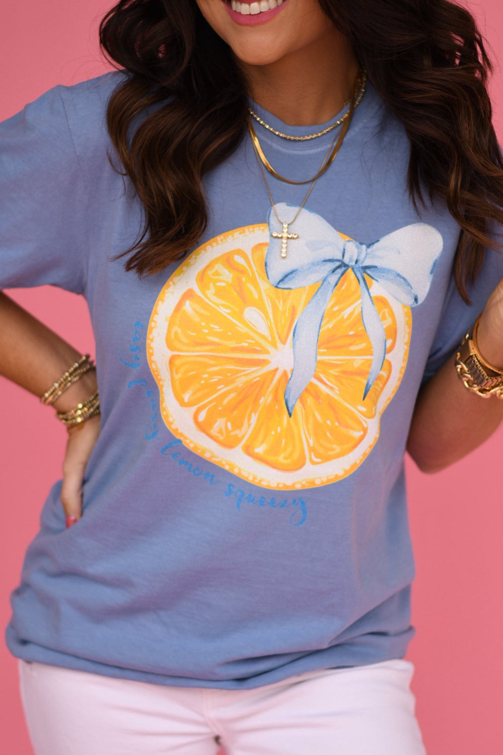 Washed denim blue graphic t-shirt featuring a yellow lemon slice with a blue bow printed on the front