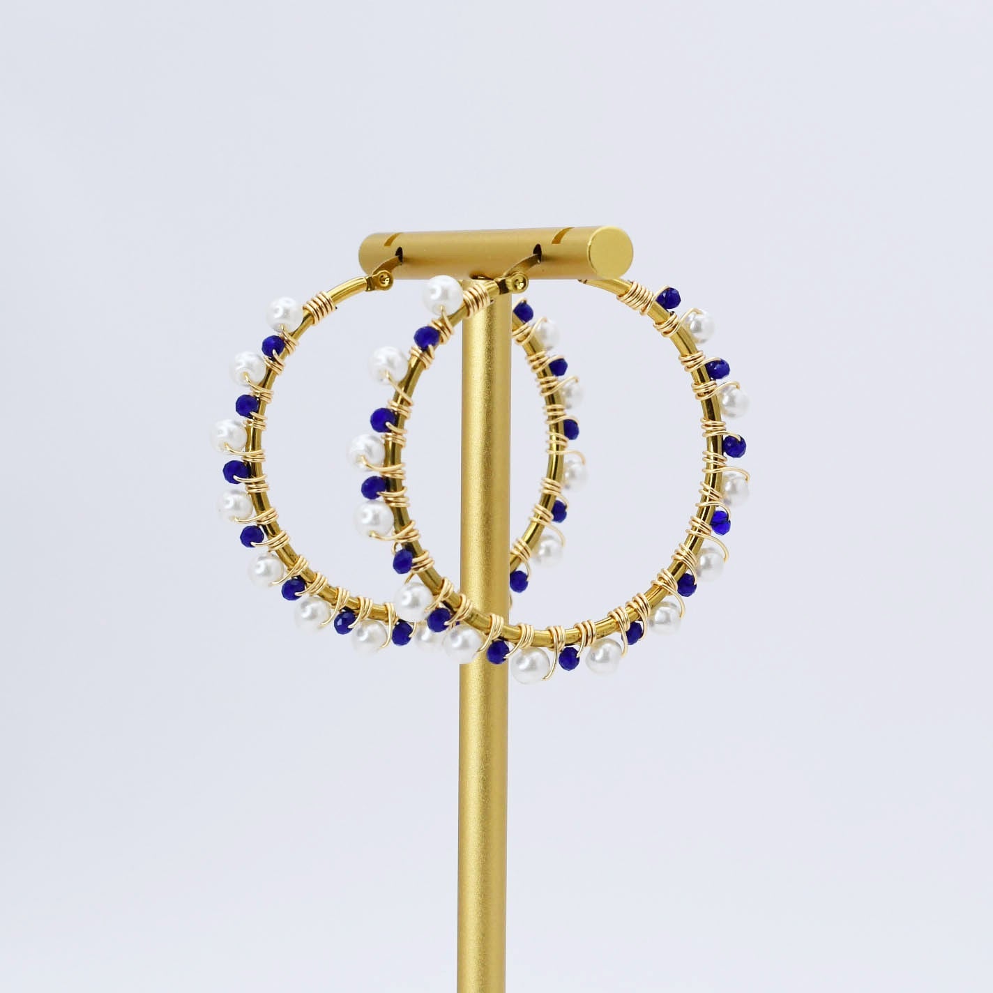 Gold hoop earrings with blue and white beads