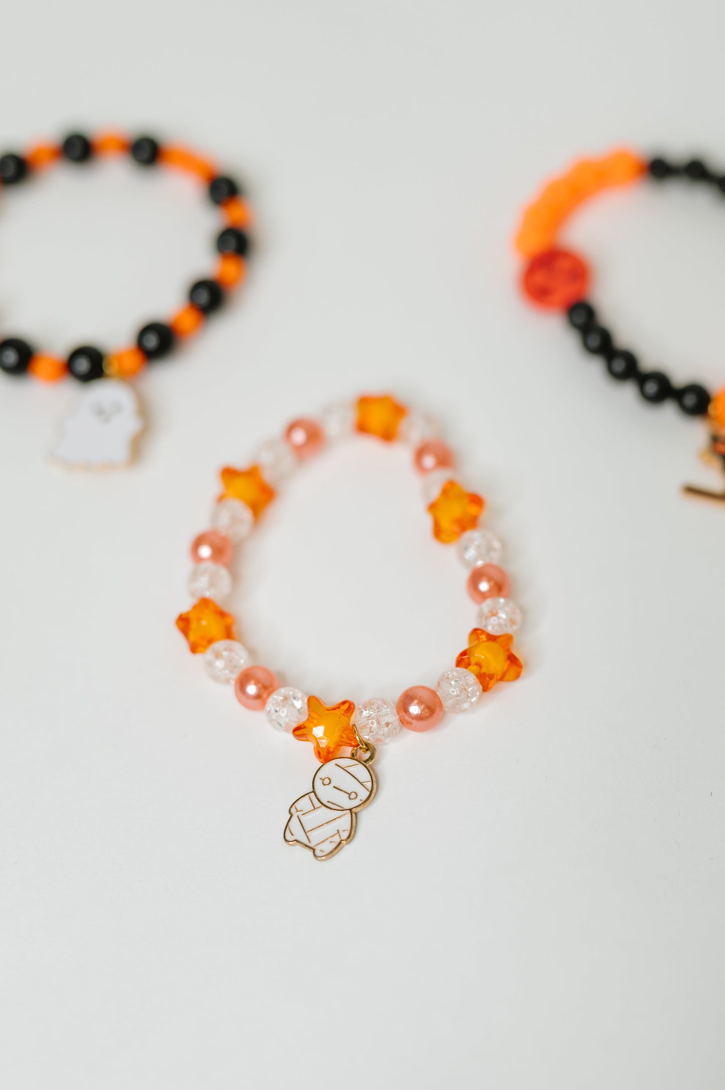 Plastic Bead stretch Halloween bracelet stack
Elastic
Gold Plated Enamel Charms
Set of 3
Ghost: 7/8” x 11/16”
Mummy: 1/2” X 7/8”
Kitty: 1 1/4” x 5/8”