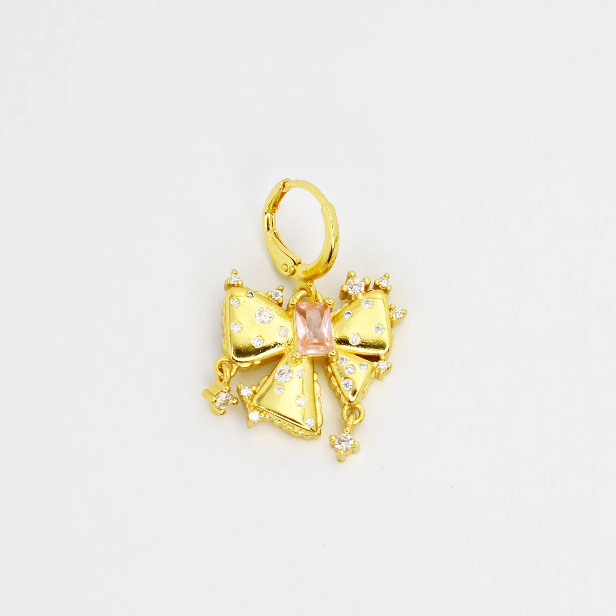 Gold bow-shaped pendant with a pink gemstone
