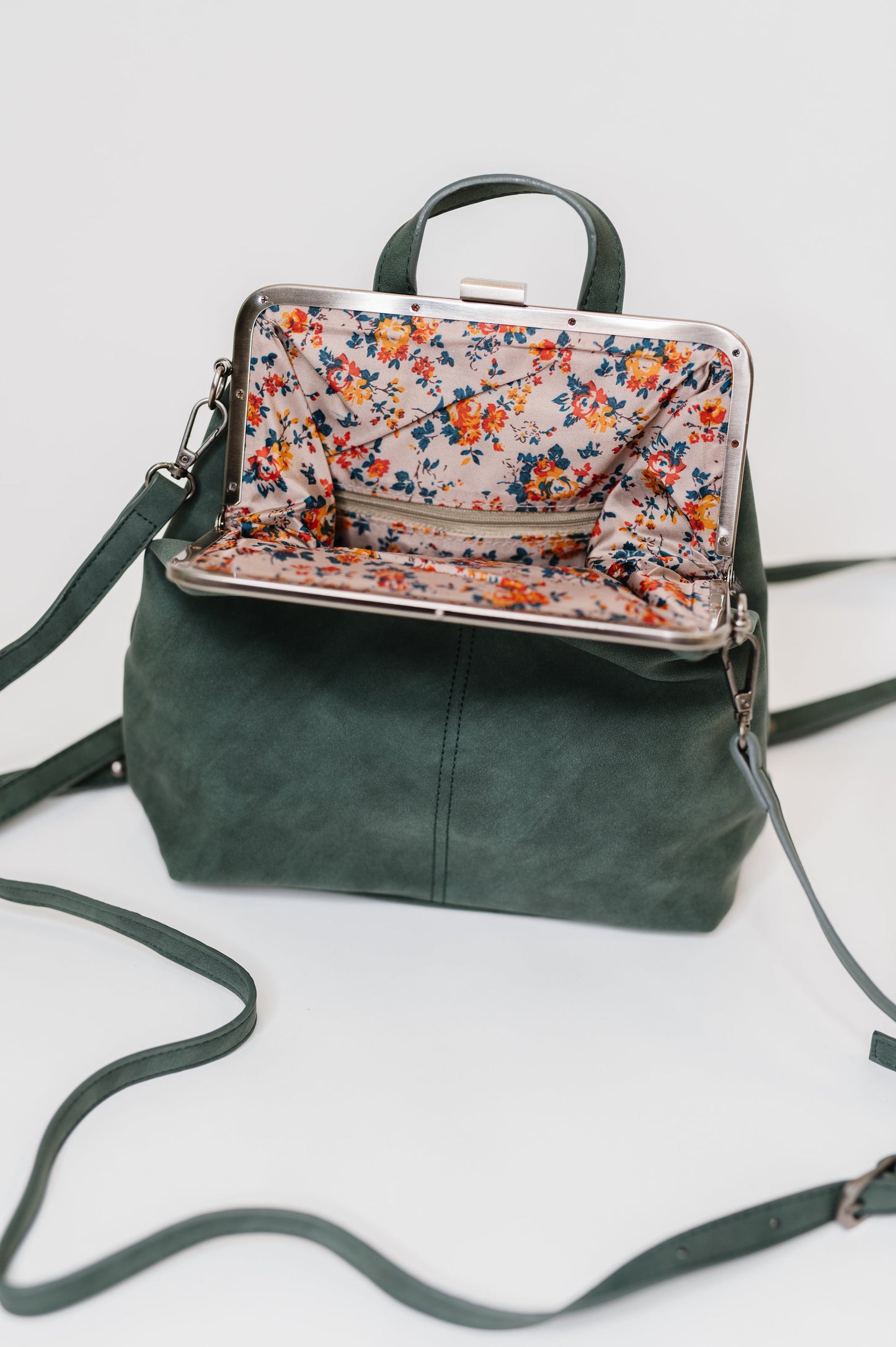 Backpack in Peacock
10.5″ Tall
9″ Wide
4″ Deep
Brass Plated Clasp Closure At Top
22" Adjustable and Removable Crossbody Strap
16" Adjustable and Removable Backpack Strap
Vertical Zipper Closure In Back
Zipper Closure Pocket Inside
Floral Printed Lining
100% Vegan Leather