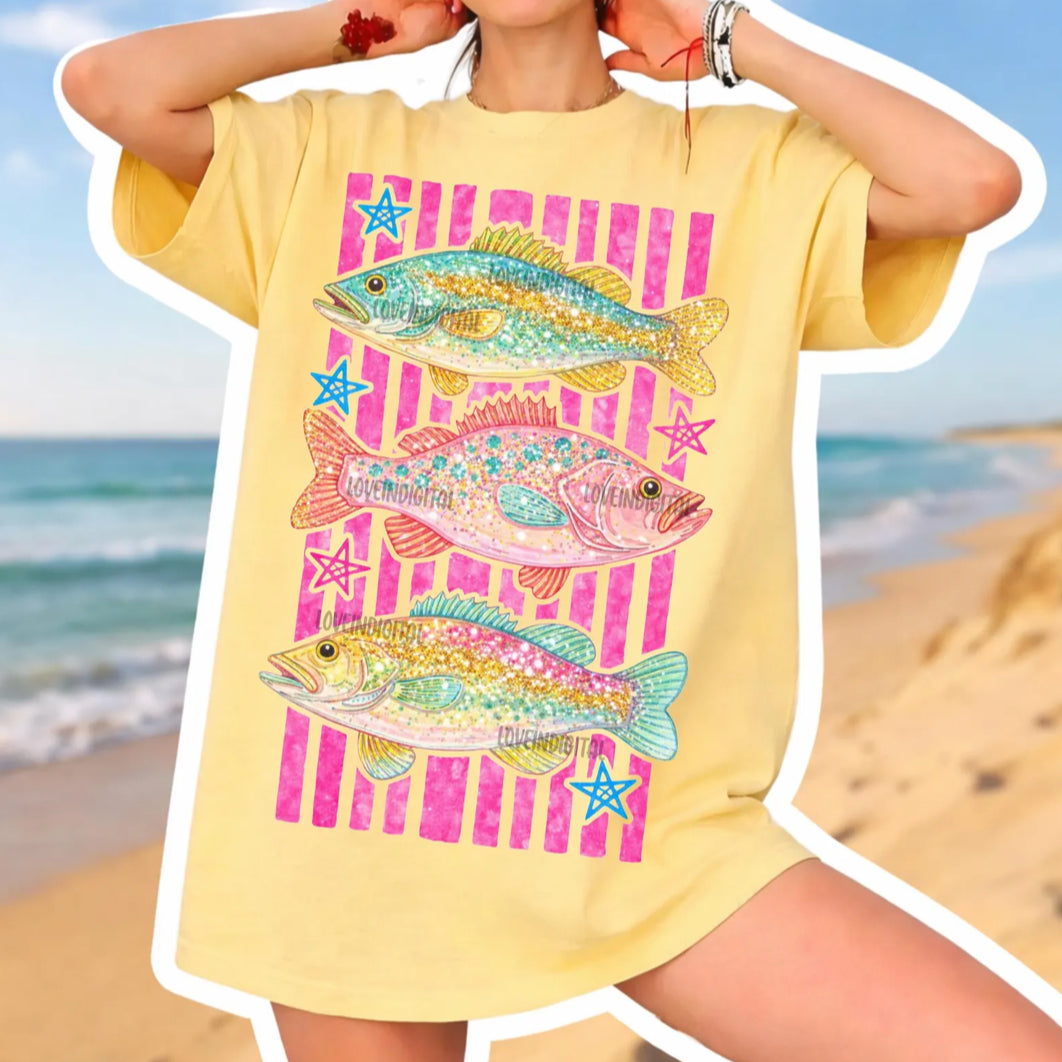 Colorful coastal fish and star graphic tee on yellow shirt with pink stripes, beach-inspired summer fishing shirt.