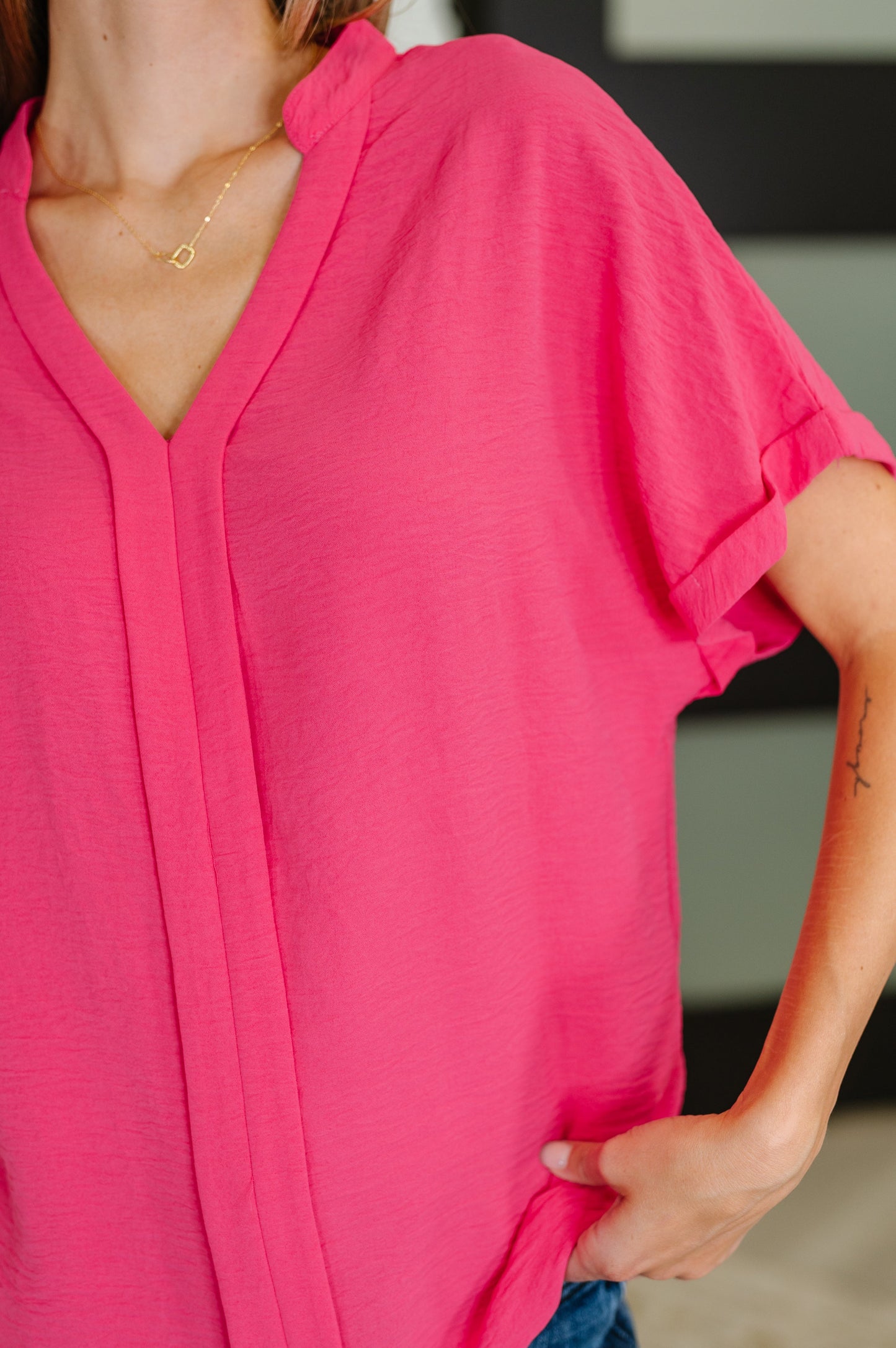 Close-up of a person wearing a Hot Pink top
