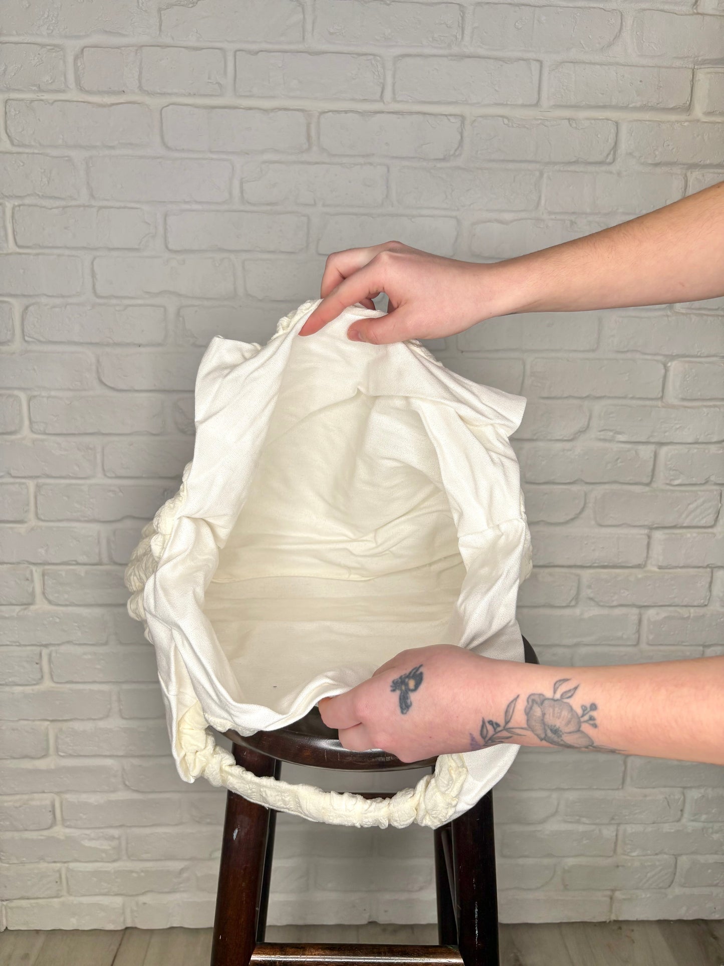 A cream-colored, textured tote bag