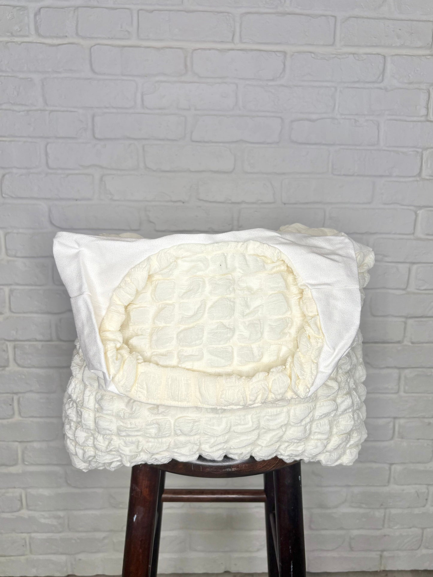 A cream-colored, textured tote bag