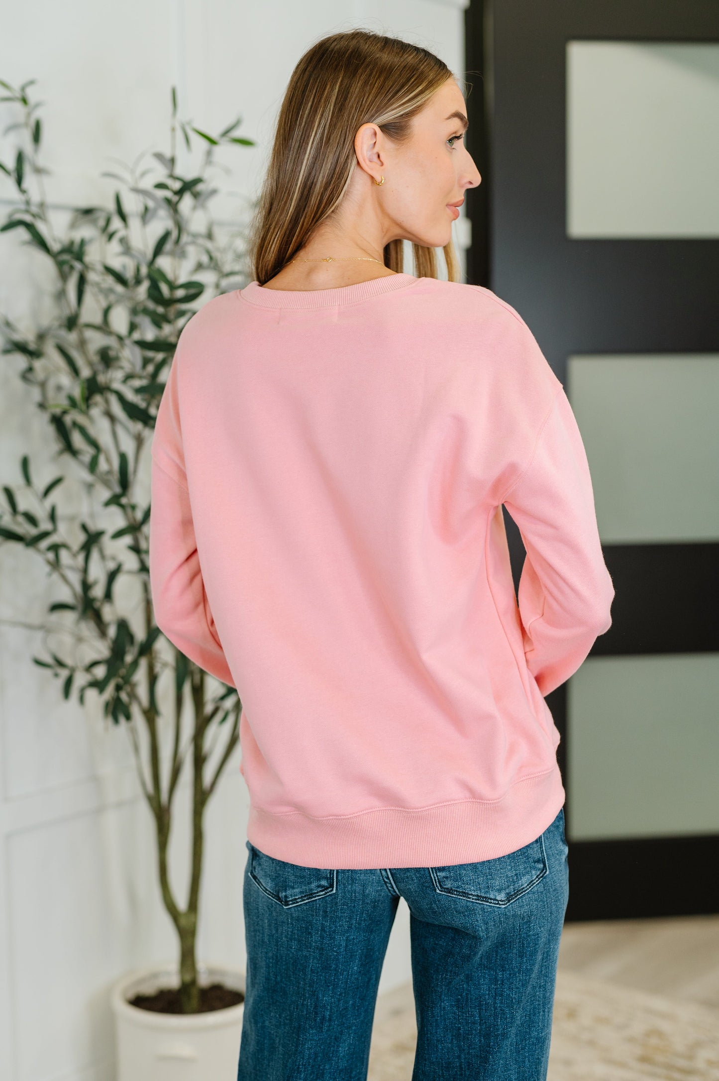 Pink 'Game Day' sweatshirt with a football graphic.