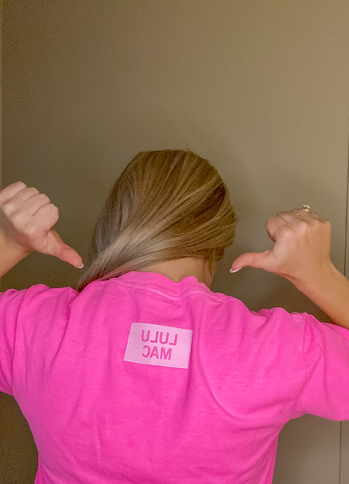 Blonde woman modeling neon pink Comfort Colors t-shirt with white polka dot Lulu Mac graphic, casual short sleeve boutique style