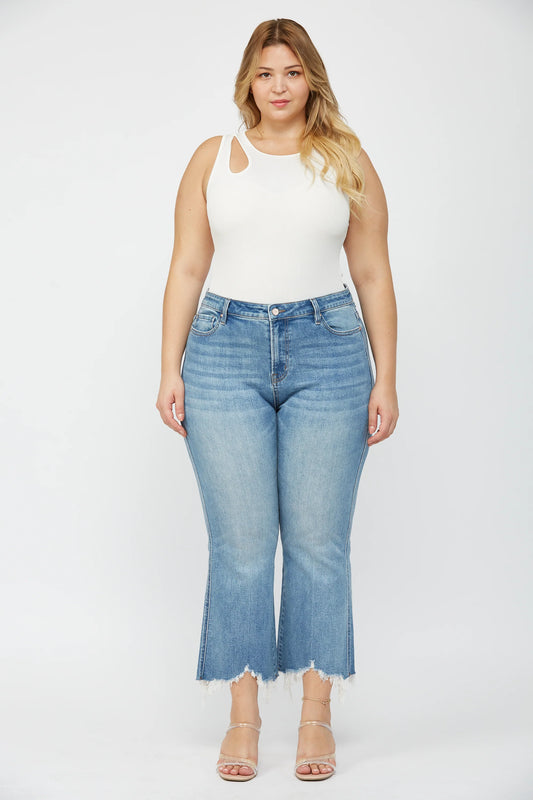 Woman wearing MICA high rise crop flare jeans with uneven raw hem and stretch denim