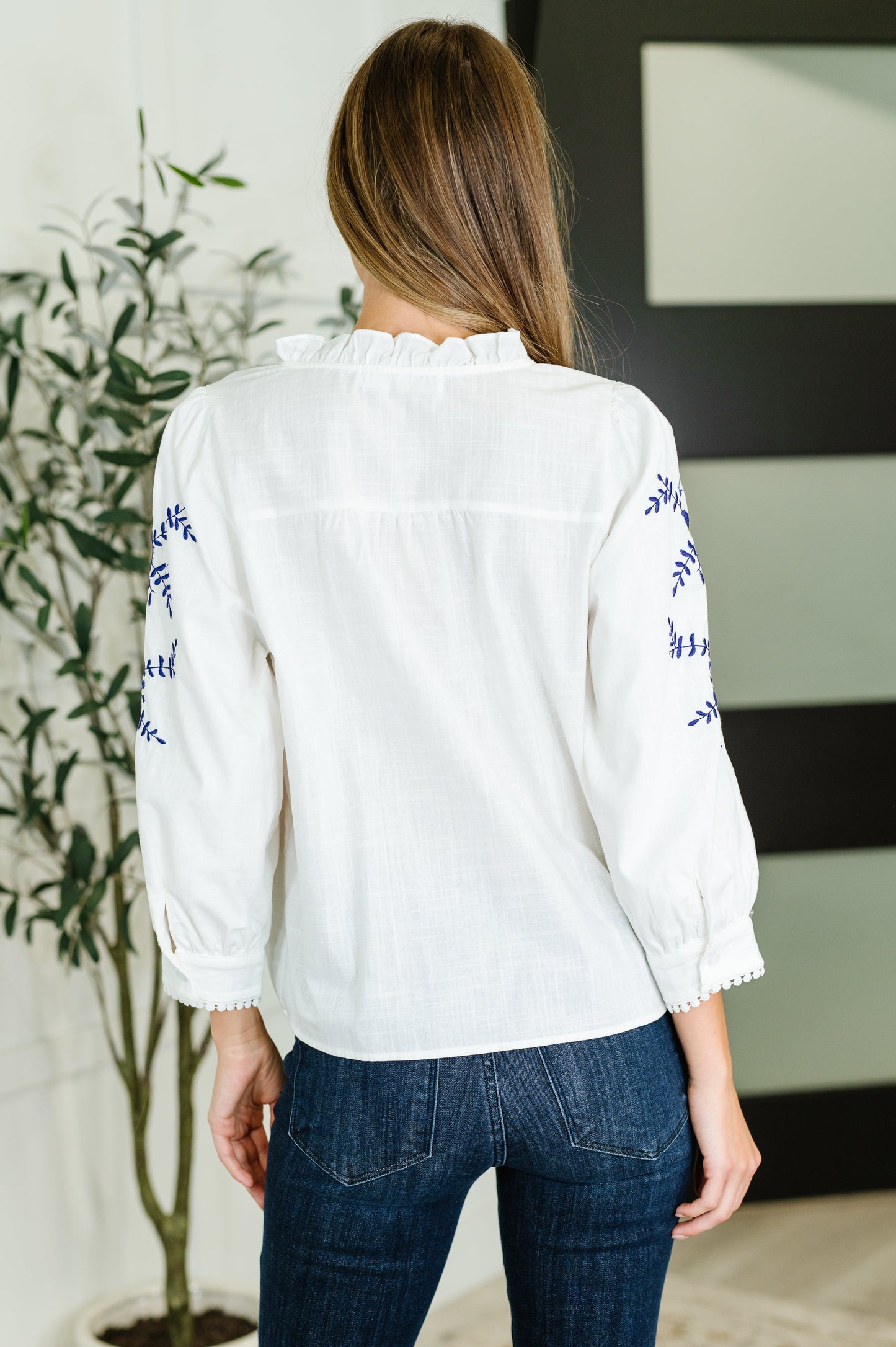 White, long sleeve, button down blouse with blue embroidery