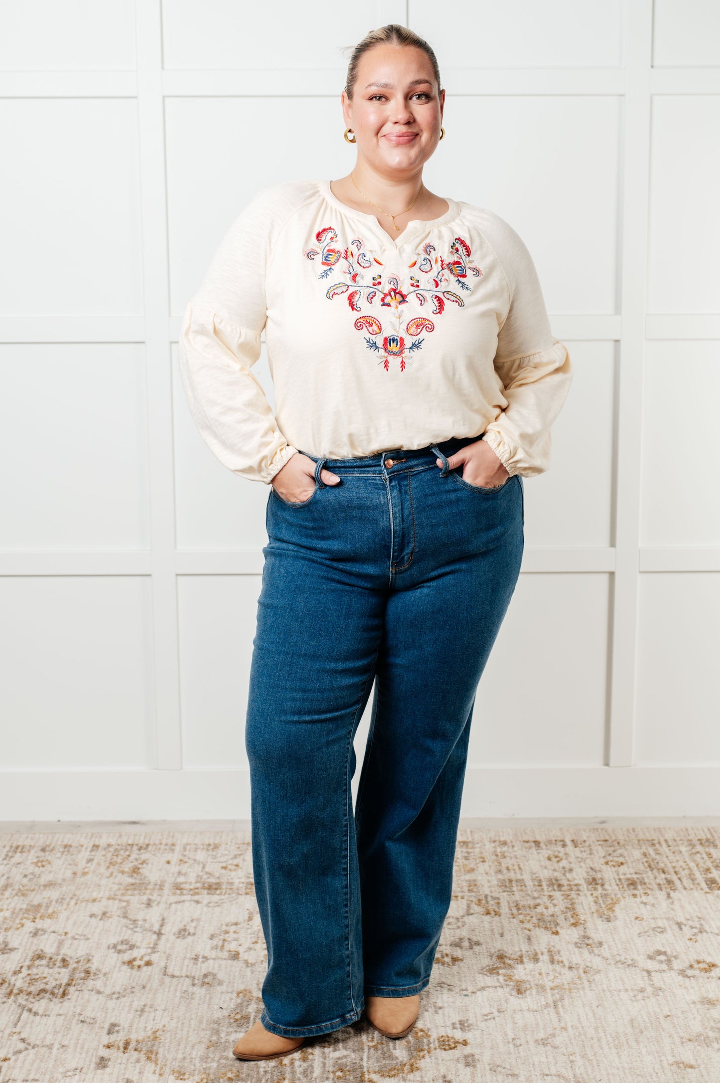 Long sleeve embroidered blouse
Lightweight Jersey Knit
Notched V-Neckline
Bishop Sleeve
Cased Elastic Sleeve Cuff
Lined Front Bodice
Scooped Hem
Machine Embroidered Details
65% Polyester, 35% Cotton
True to Size