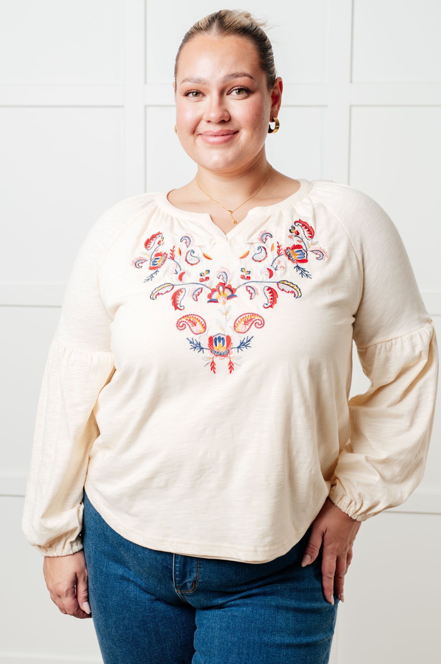 Long sleeve embroidered blouse
Lightweight Jersey Knit
Notched V-Neckline
Bishop Sleeve
Cased Elastic Sleeve Cuff
Lined Front Bodice
Scooped Hem
Machine Embroidered Details
65% Polyester, 35% Cotton
True to Size