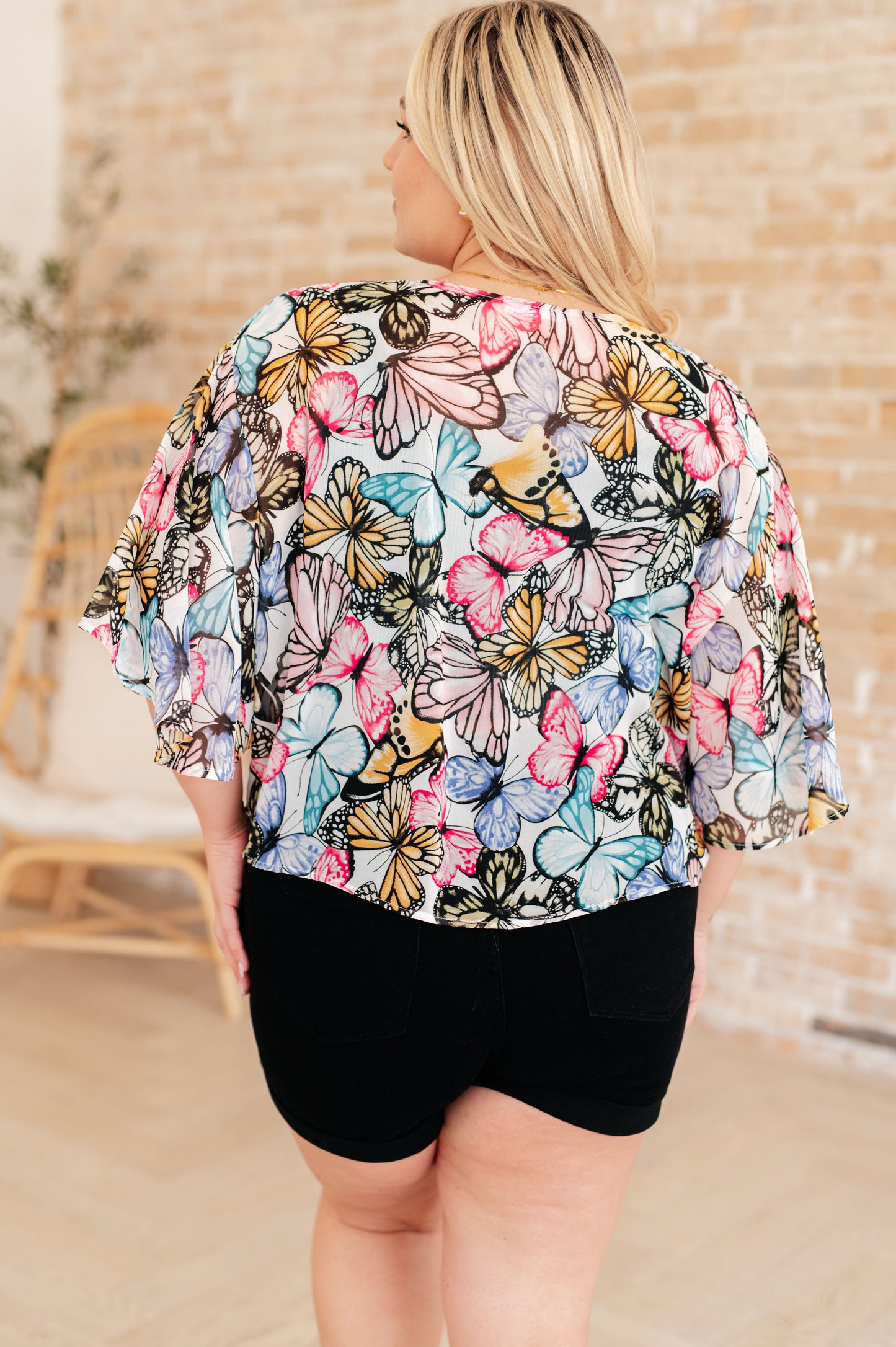Light weight woven, sheer, drop shoulder flutter sleeve, kimono fit, tie front, scooped hem top