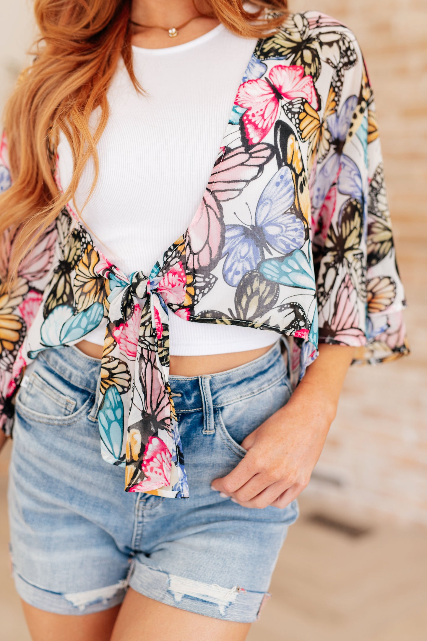 Light weight woven, sheer, drop shoulder flutter sleeve, kimono fit, tie front, scooped hem top
