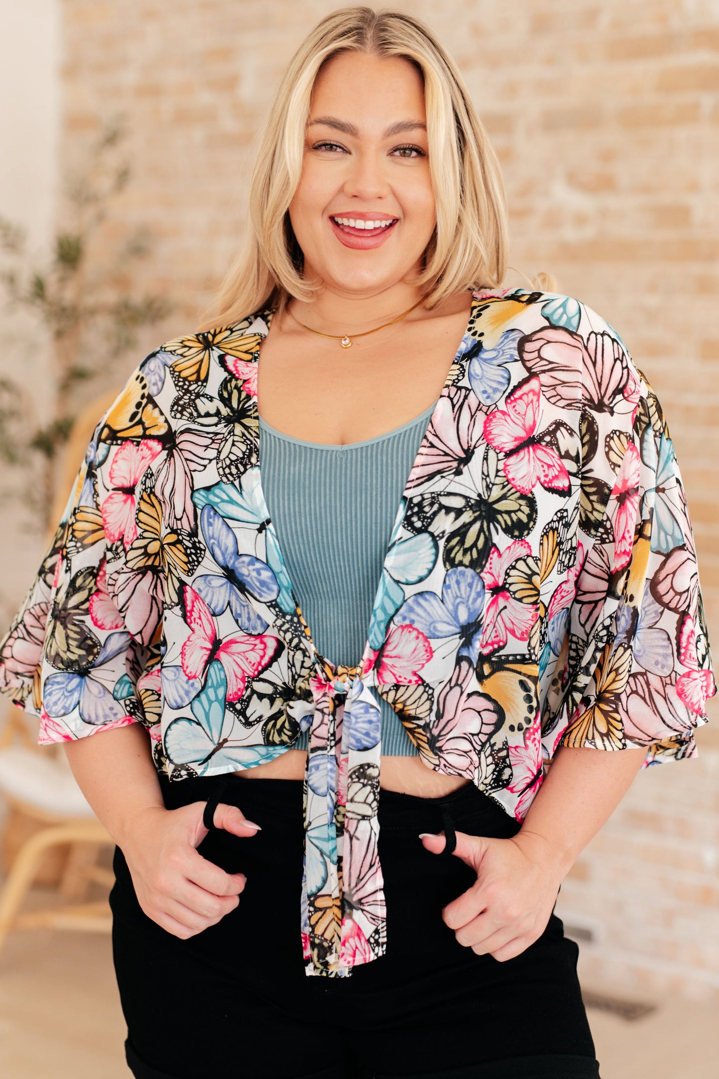 Light weight woven, sheer, drop shoulder flutter sleeve, kimono fit, tie front, scooped hem top