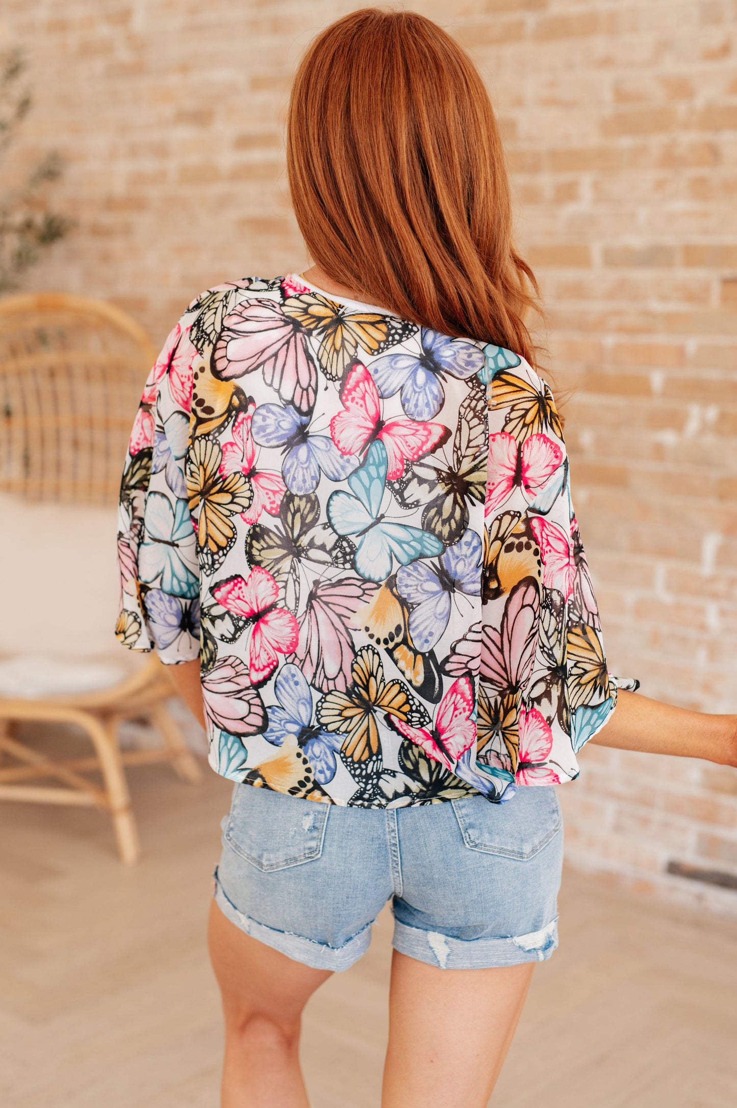 Light weight woven, sheer, drop shoulder flutter sleeve, kimono fit, tie front, scooped hem top