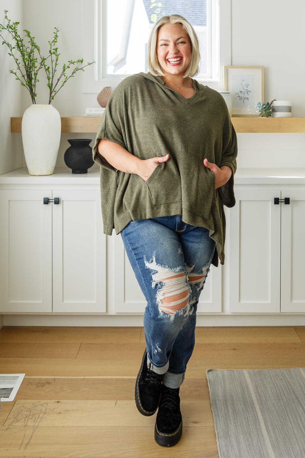 Olive Ribbed Jersey Knit Hooded Poncho by White Birch
Hooded V-Neckline
Poncho Style
Tacked Sides
Kangaroo Pocket
78% Polyester, 18% Rayon, 4% Spandex
True to Size, Oversized Fit