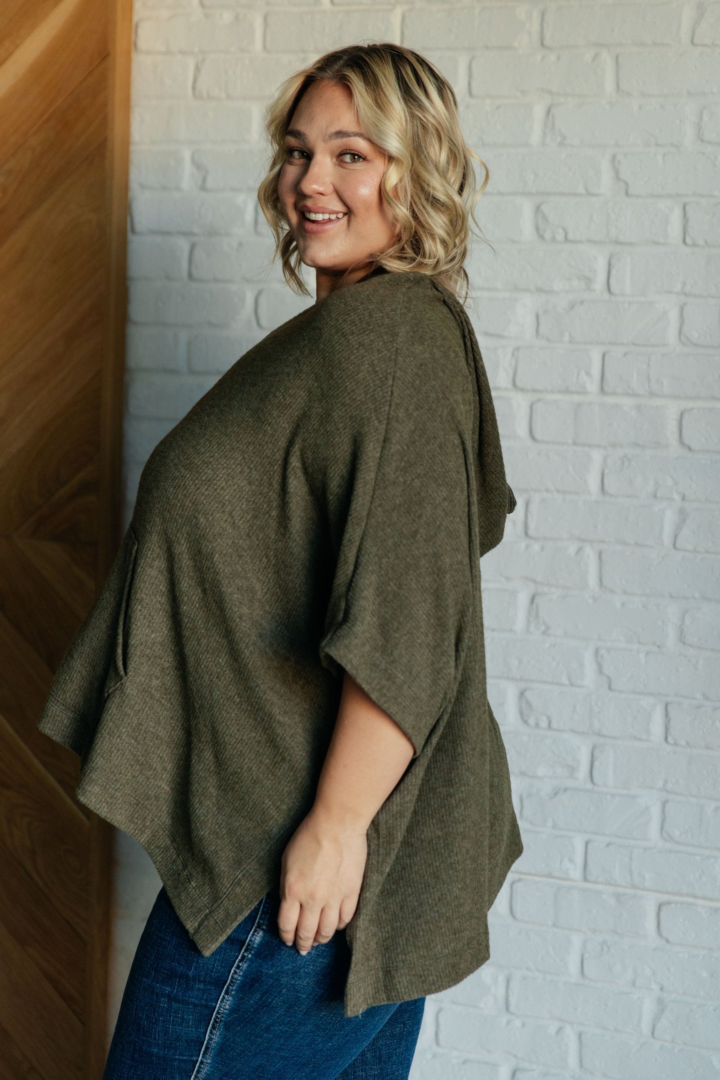 Olive Ribbed Jersey Knit Hooded Poncho by White Birch
Hooded V-Neckline
Poncho Style
Tacked Sides
Kangaroo Pocket
78% Polyester, 18% Rayon, 4% Spandex
True to Size, Oversized Fit
