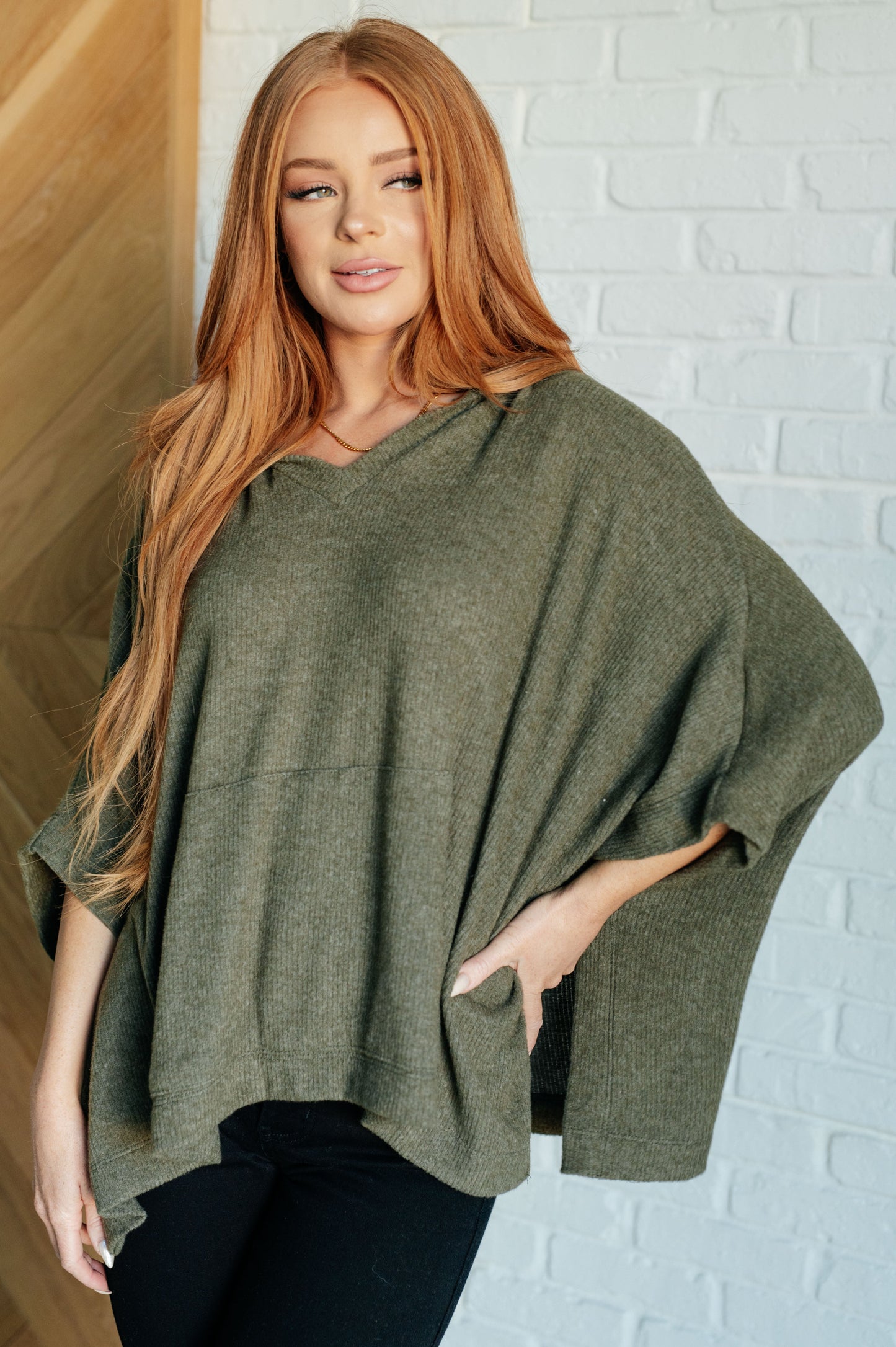 Olive Ribbed Jersey Knit Hooded Poncho by White Birch
Hooded V-Neckline
Poncho Style
Tacked Sides
Kangaroo Pocket
78% Polyester, 18% Rayon, 4% Spandex
True to Size, Oversized Fit