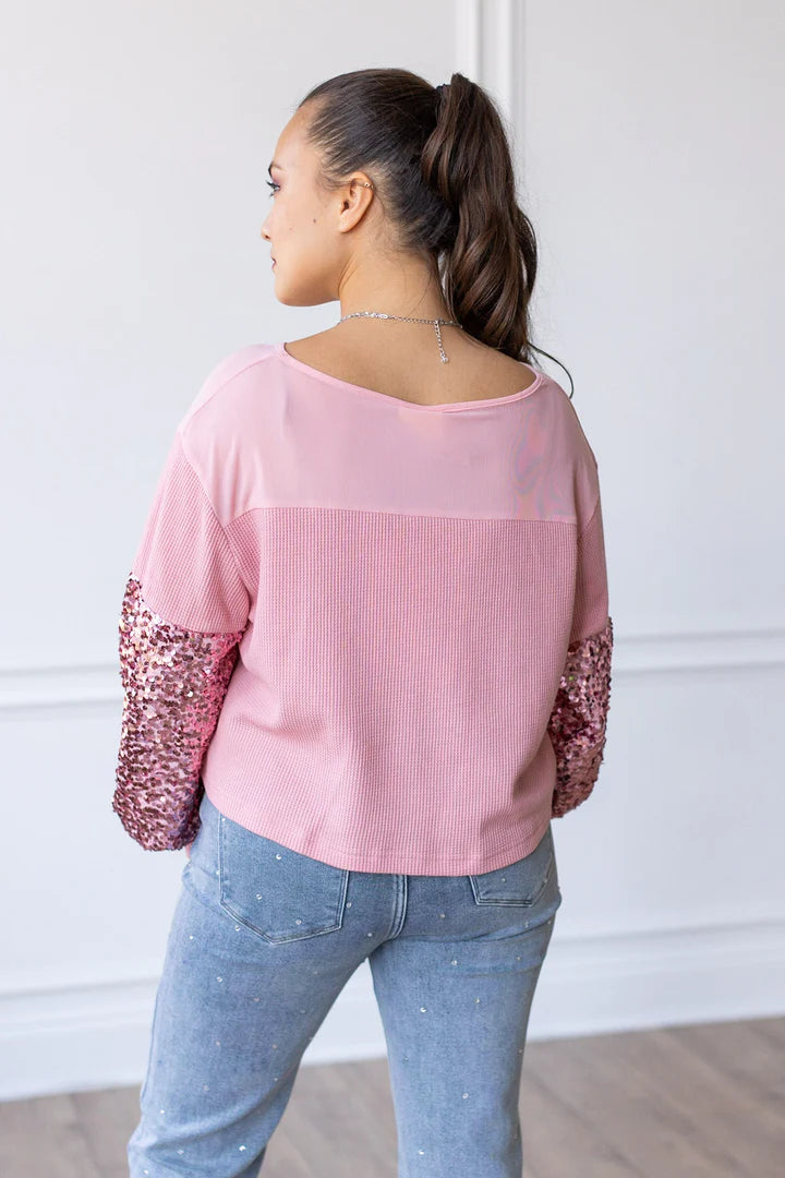 Rosy pink waffle knit women’s top featuring sequin long sleeves by Southern Grace, styled with casual denim