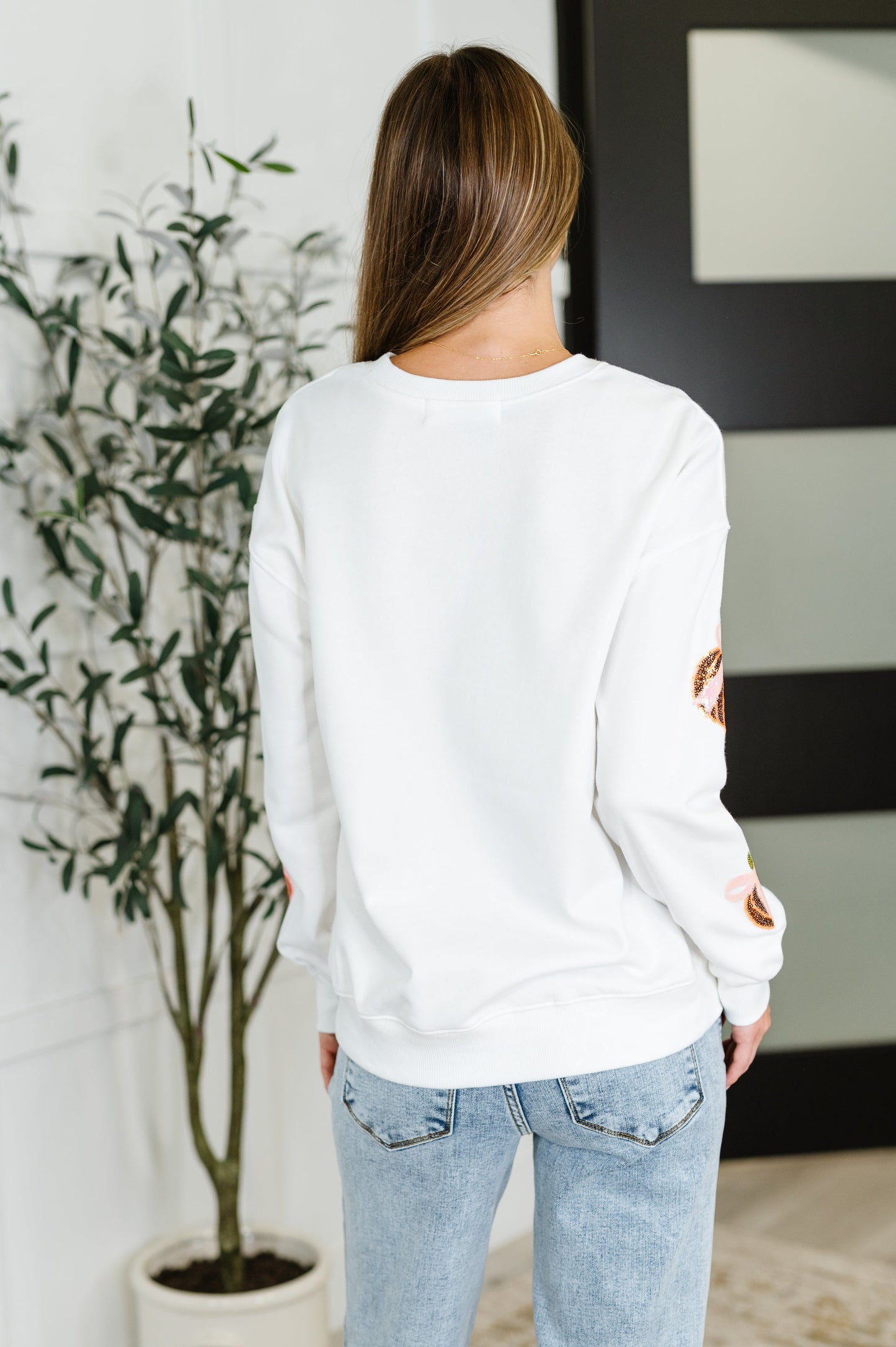 White long sleeve sequin pullover top with pumpkin patterns