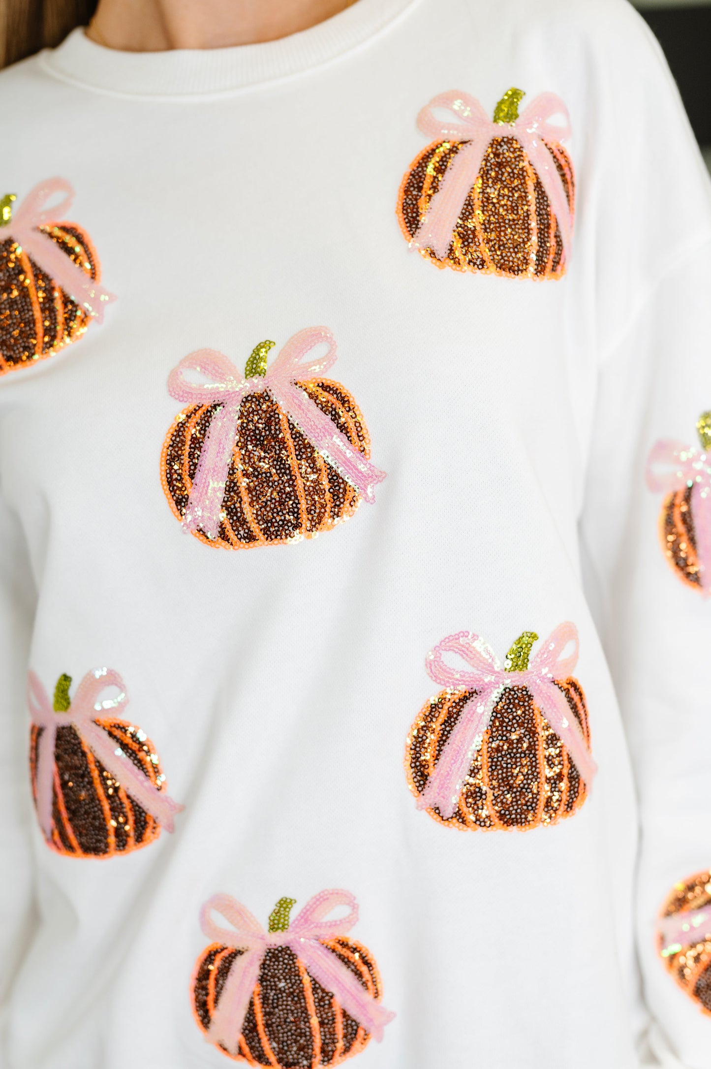 White long sleeve sequin pullover top with pumpkin patterns