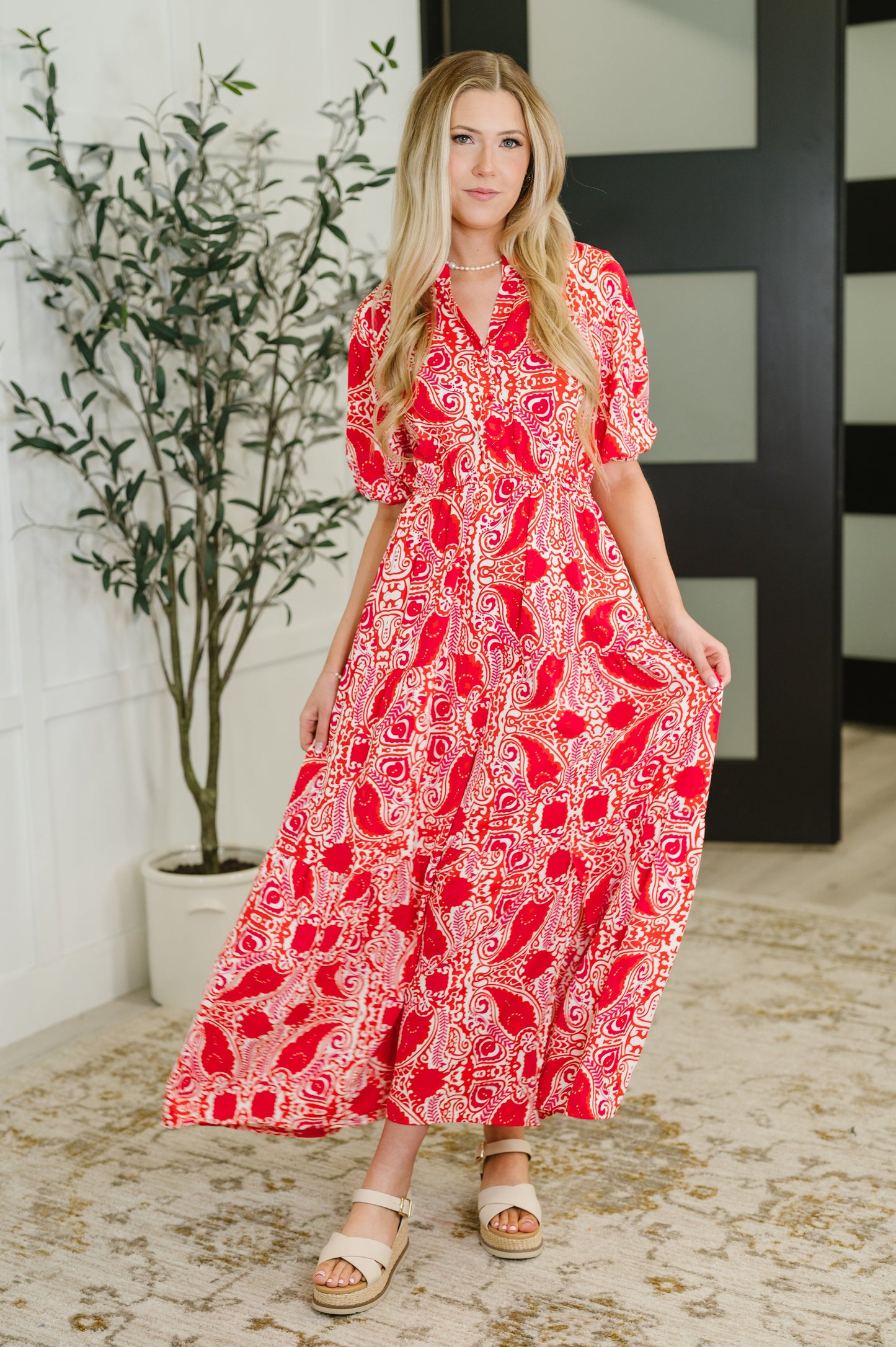 Red Floral patterned maxi dress
Poplin Woven
No-Stretch
V-Neck
Half Front Buttons
Dolman Balloon Sleeve
Cased Elastic Sleeve Cuff
Functional Side Pockets
Elastic Waist
Gathered Tiered
100% Polyester
True to Size