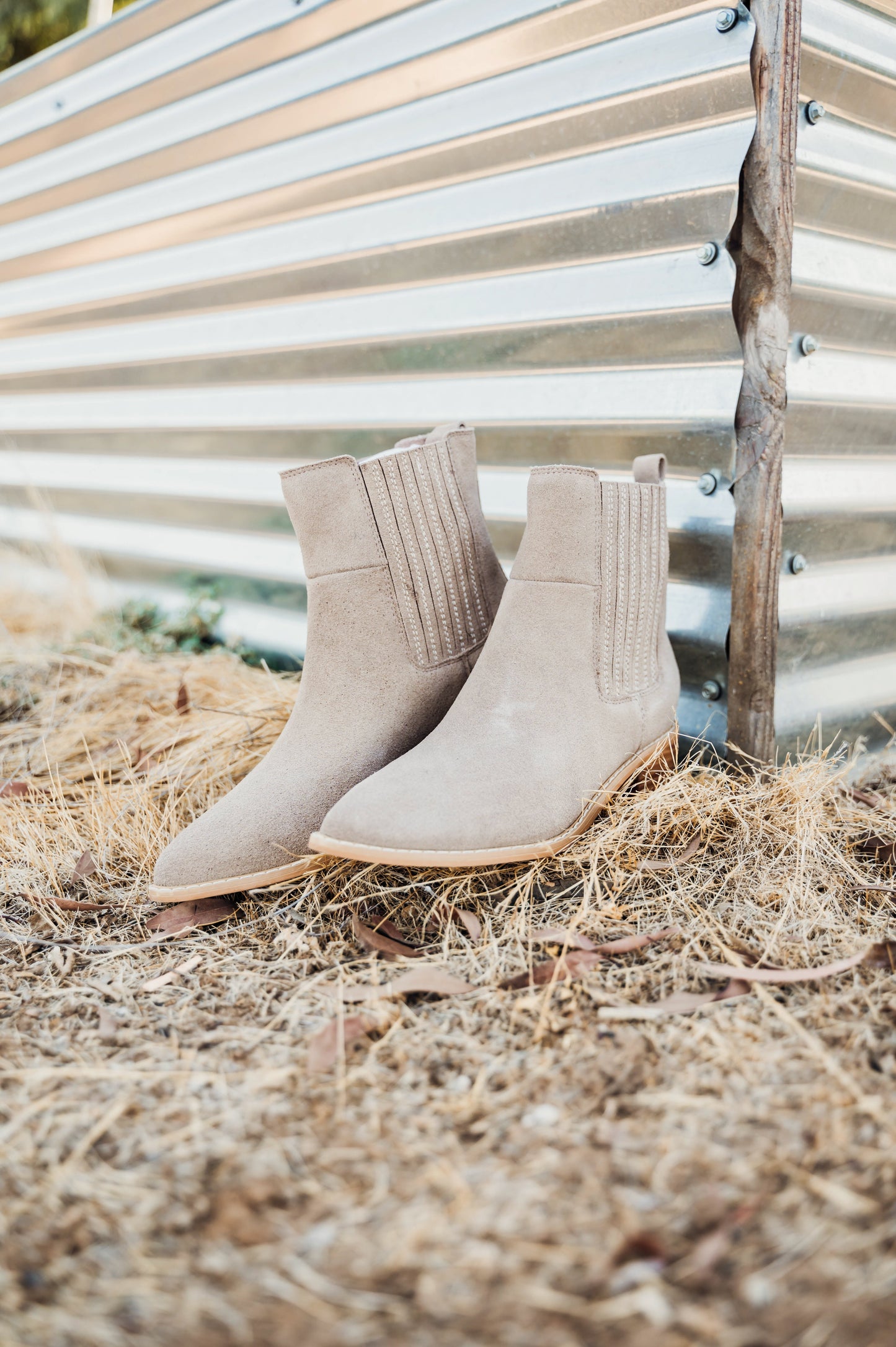 Taupe genuine suede pull on booties by Naughty Monkey.