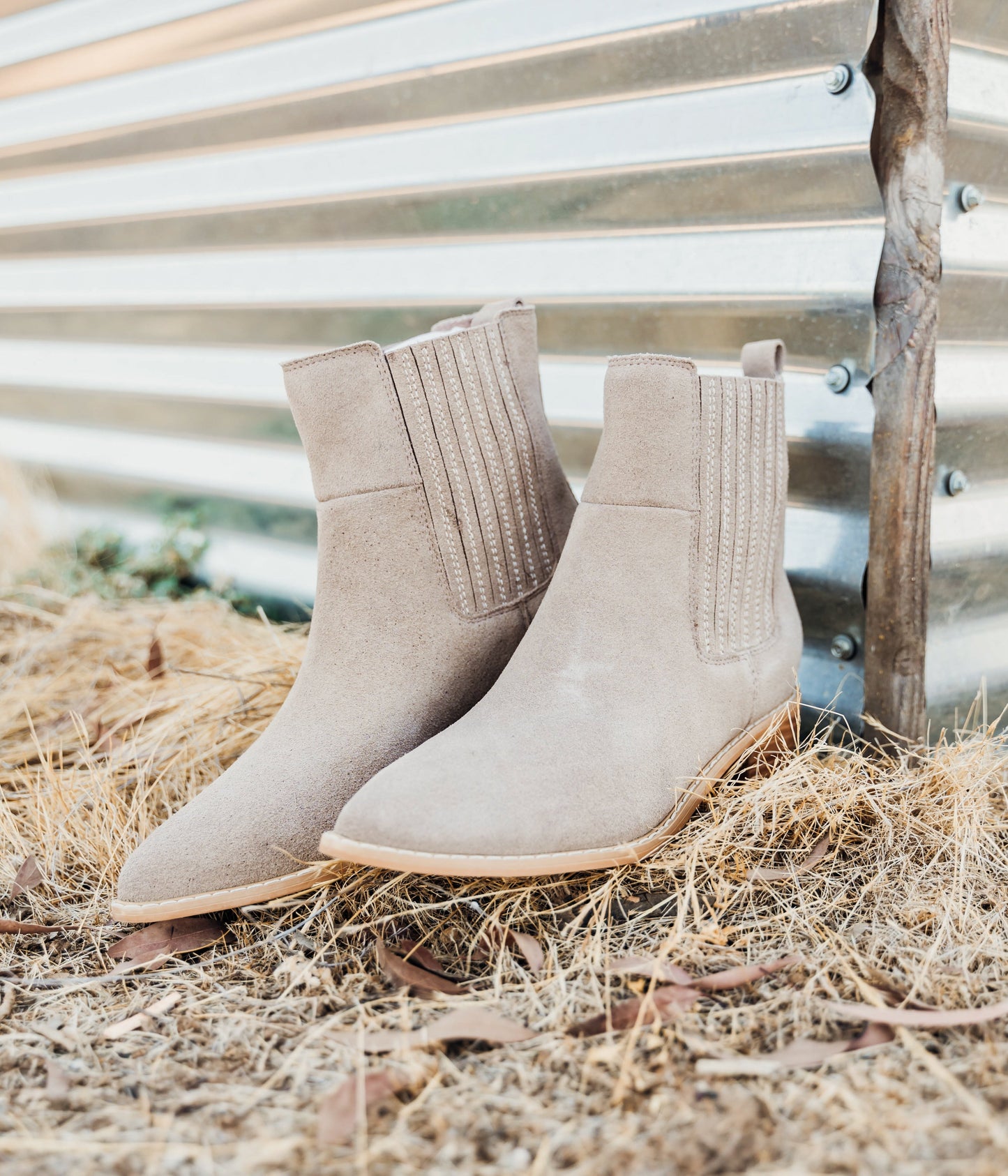 Taupe genuine suede pull on booties by Naughty Monkey.