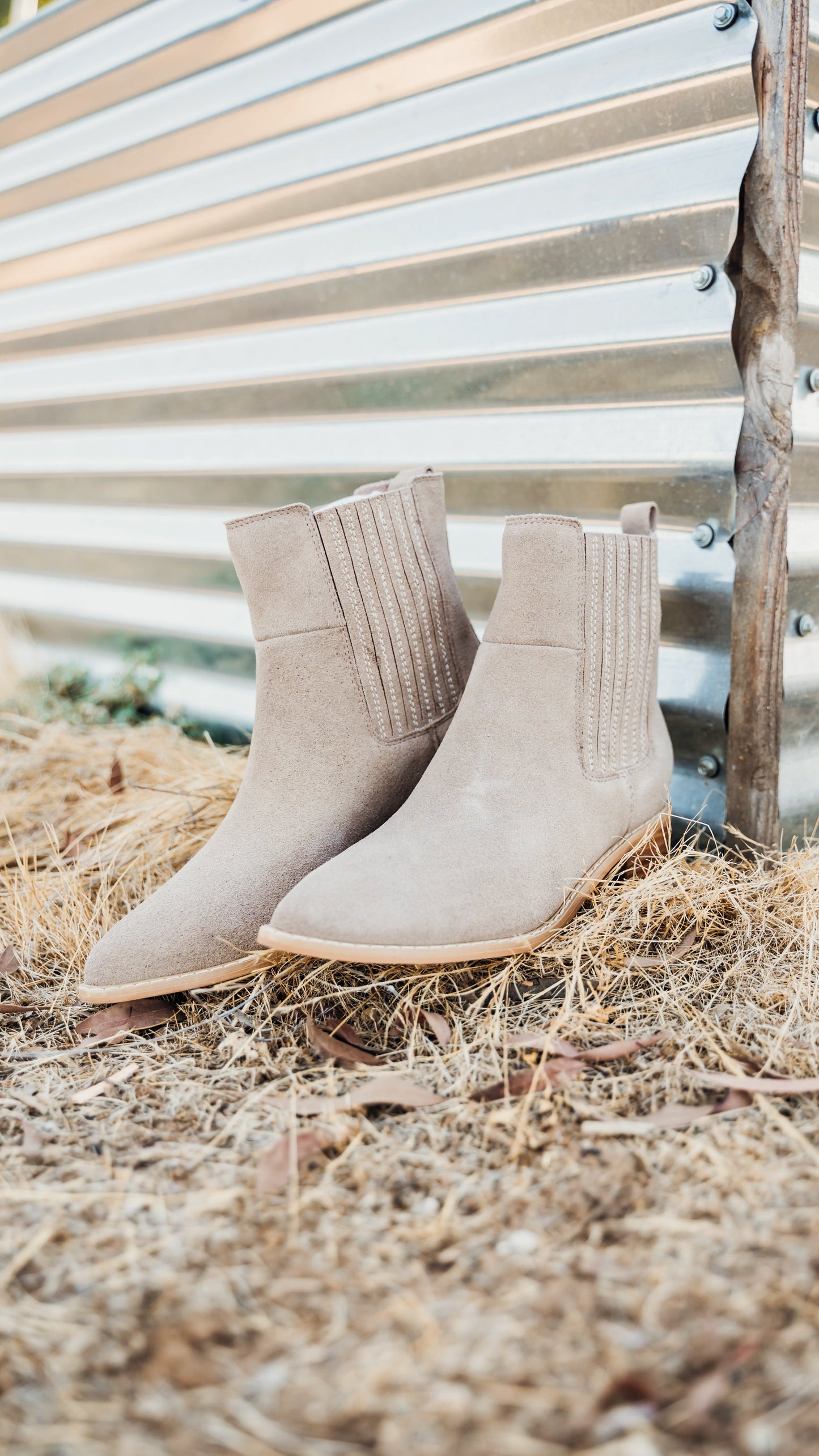 Taupe genuine suede pull on booties by Naughty Monkey.