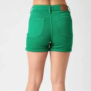 Close-up of Judy Blue fray hem Kelly green plus size denim shorts cuffed