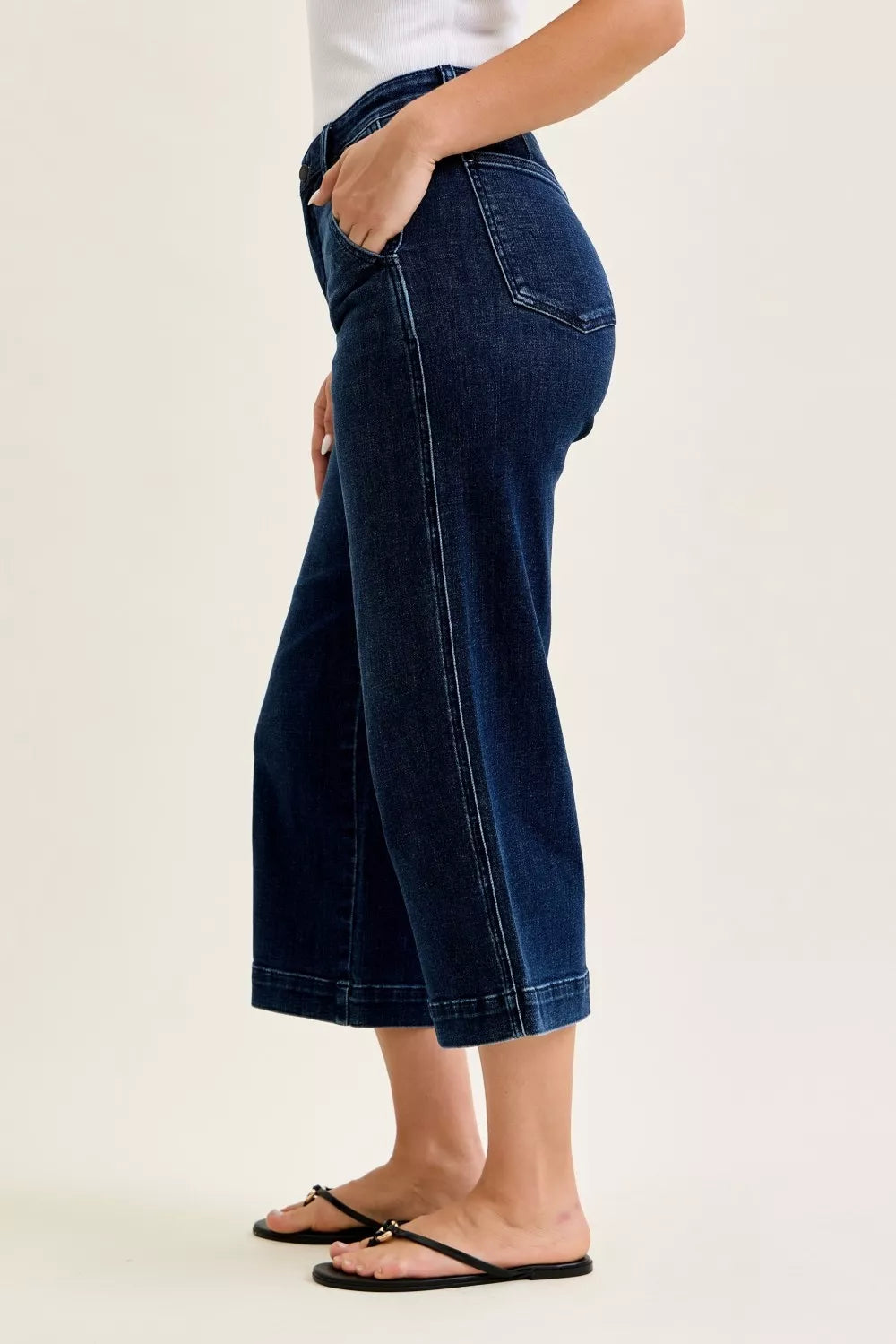 Side profile of wide leg ankle jeans showing relaxed fit and cropped length