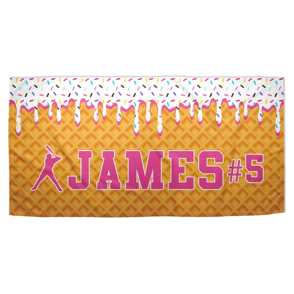 Towel with waffle pattern, pink icing, sprinkles, and 'JAMES #5' text on a white background