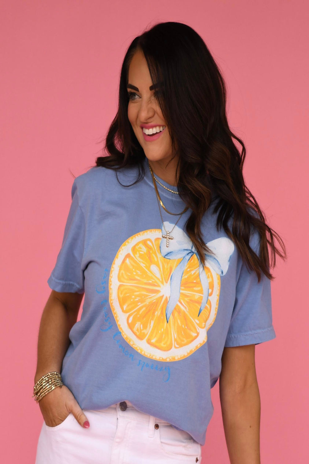 Washed denim blue graphic t-shirt featuring a yellow lemon slice with a blue bow printed on the front