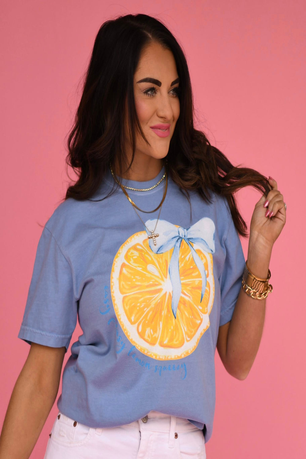 Washed denim blue graphic t-shirt featuring a yellow lemon slice with a blue bow printed on the front
