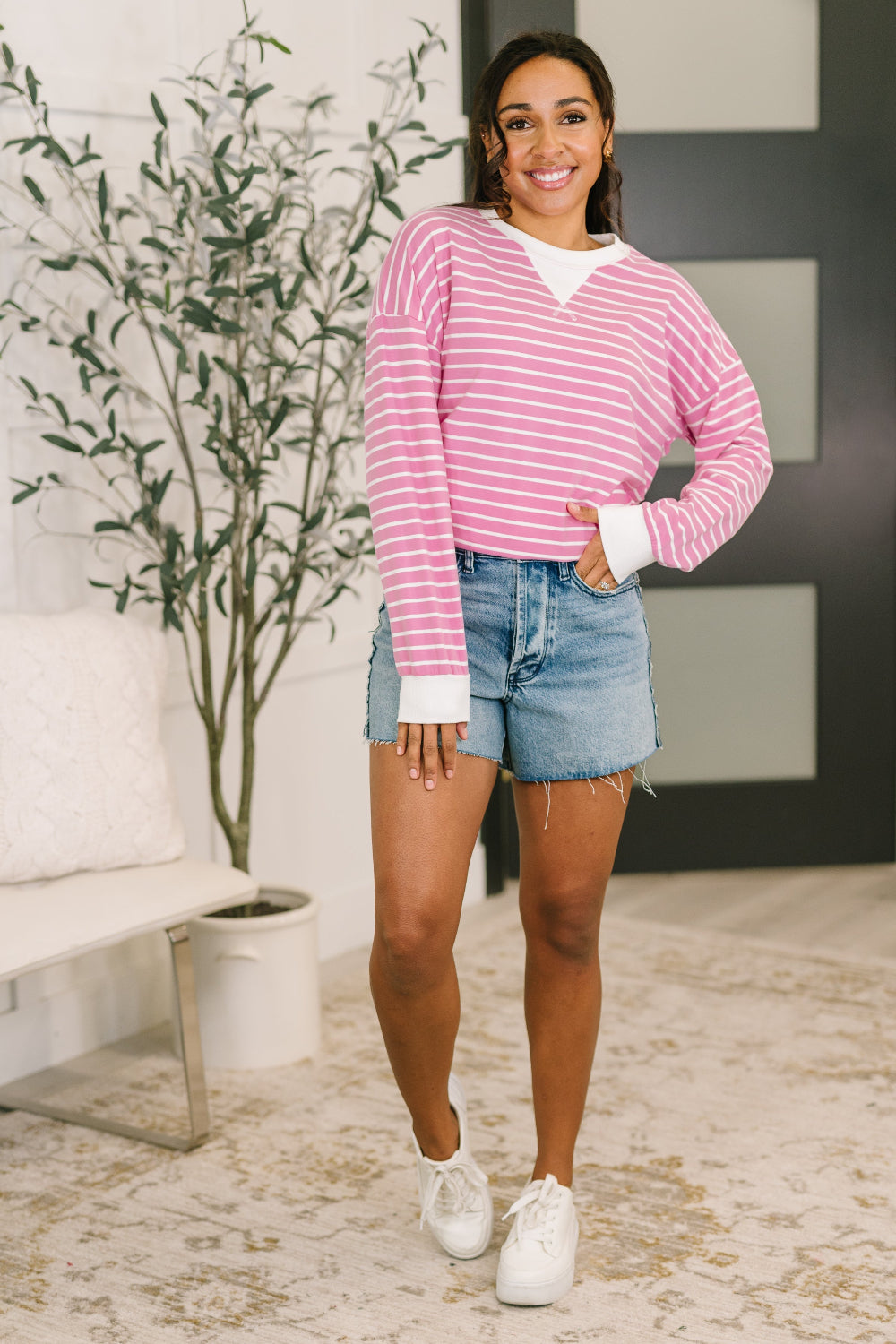 Model wearing Zenana Almost Therapeutic Drop Shoulder Pullover in Candy Pink styled with denim shorts and white sneakers