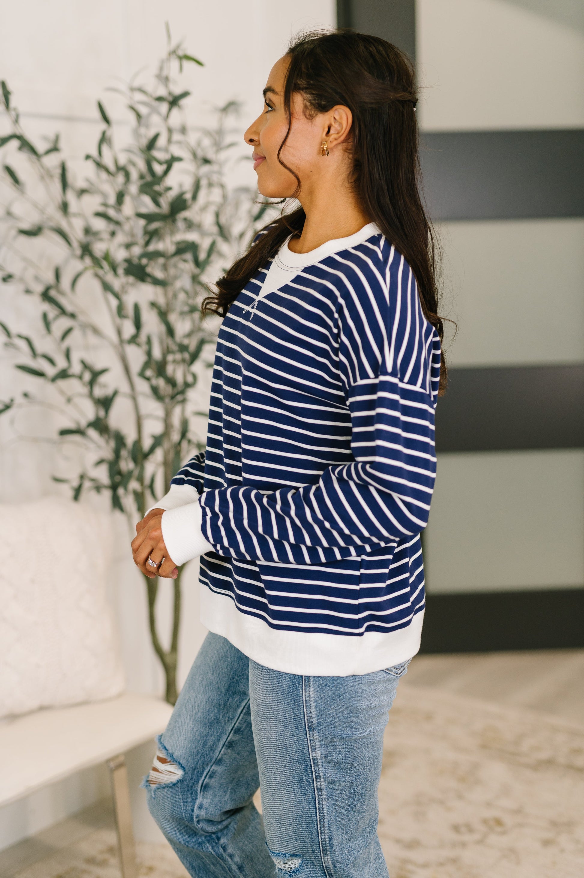 Model wearing Zenana Almost Therapeutic Drop Shoulder Pullover in Navy with light wash jeans and white sneakers