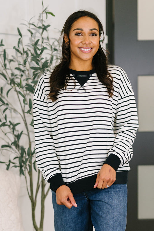Model wearing Zenana Almost Therapeutic Drop Shoulder Pullover in Black and White striped design with contrast trim