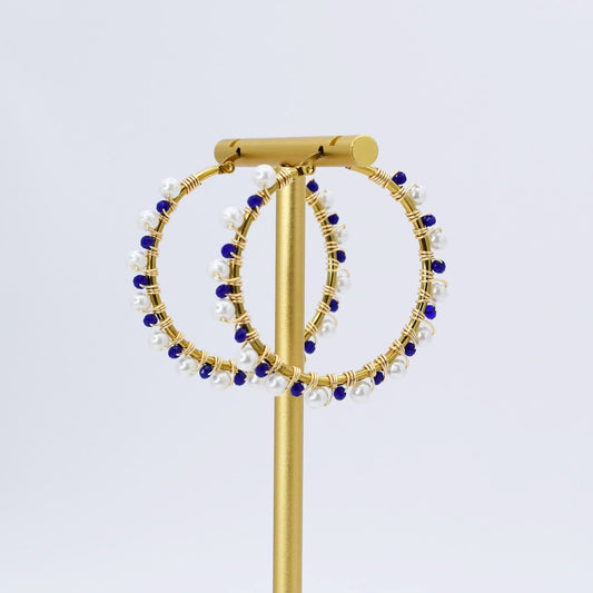 Gold hoop earrings with blue and white beads 