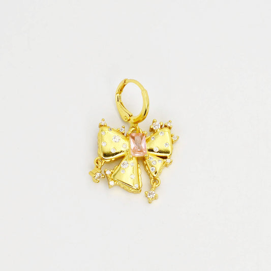 Gold bow-shaped pendant with a pink gemstone 