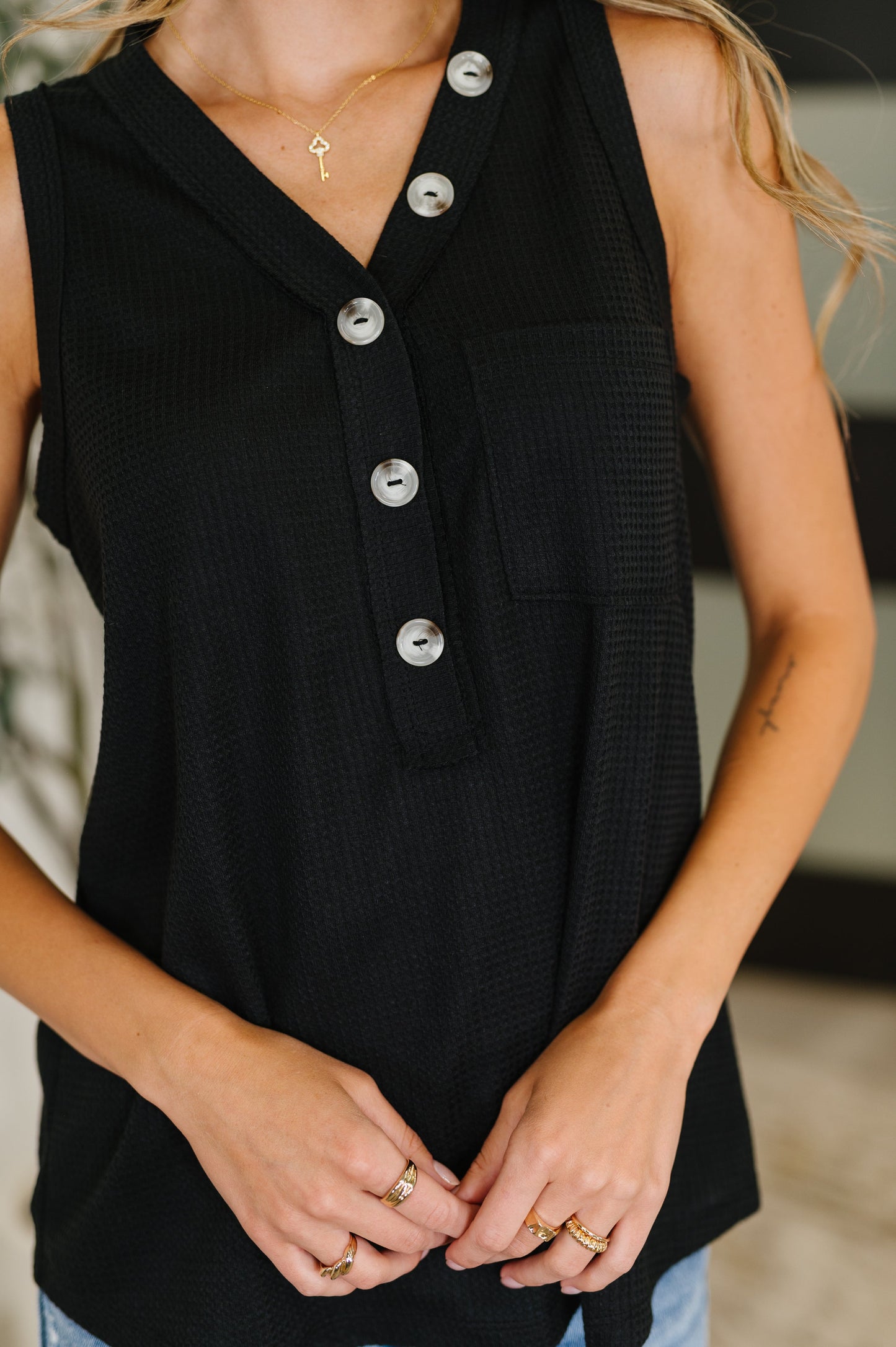 black sleeveless top with buttons by Andree by Unit