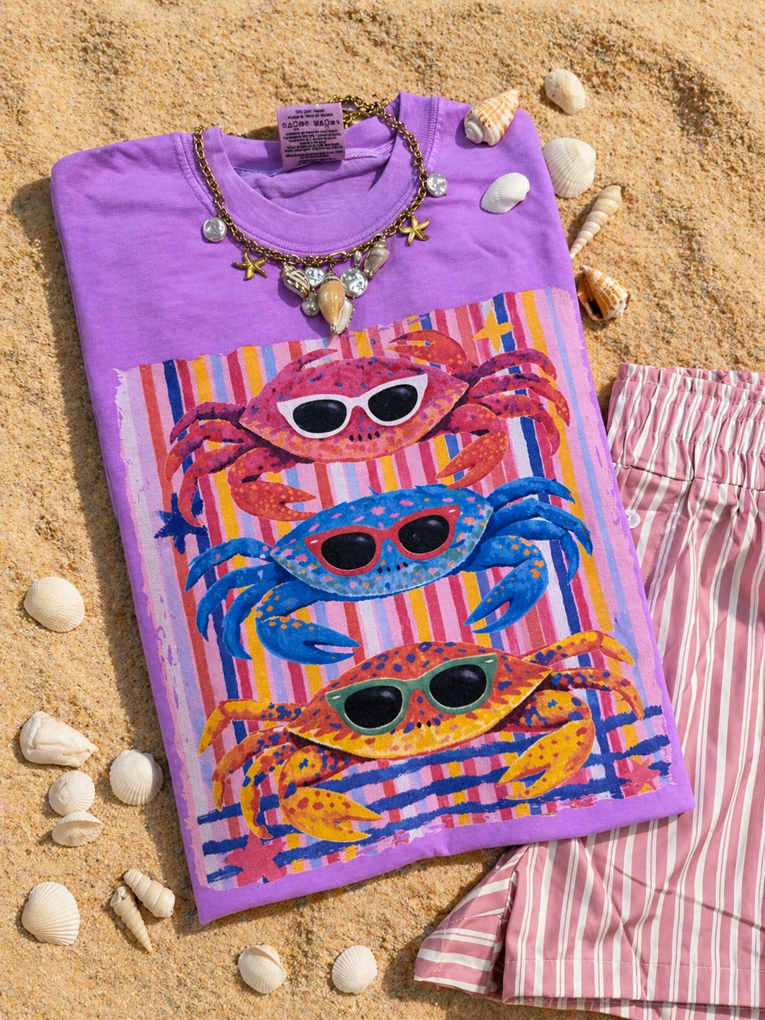 Neon violet Comfort Colors tee with colorful sunglasses crabs and striped beach-inspired graphic design.

Shopify Tags