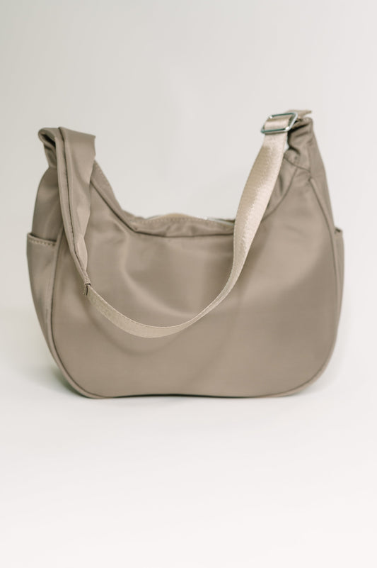 Easy Clean Nylon shoulder bag
Height: 6.5” Width: 10 3/4” Depth: 4”
Adjustable Strap 22 1/4”
Silver Hardware
Back Zipper Pocket 7” X 4”
Inside Patch Pocket
Inside Zipper Pocket
