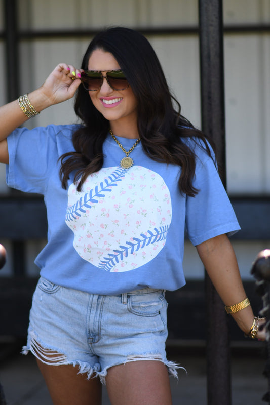 Woman wearing washed denim floral baseball graphic tee with denim shorts and sunglasses, styled for spring and summer casual outfit