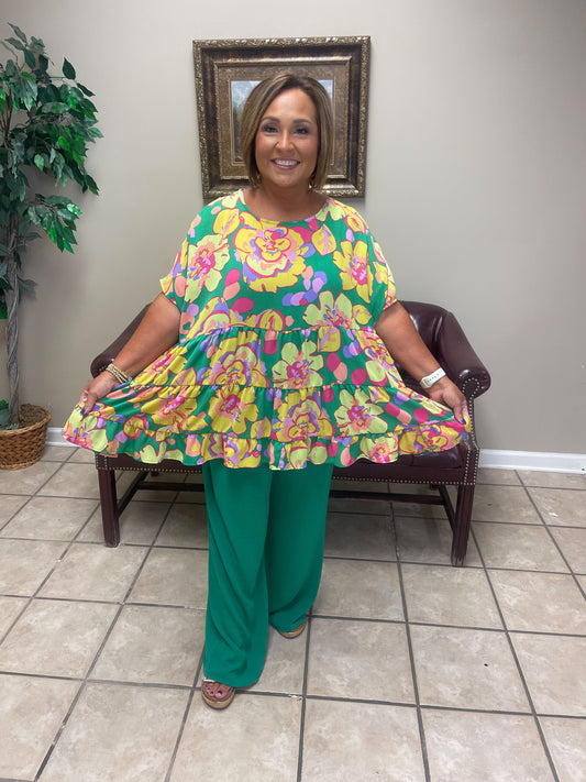 colorful floral top and green pants 
