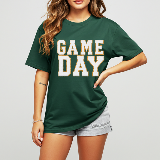 Person wearing a green 'GAMEDAY' t-shirt on a plain background