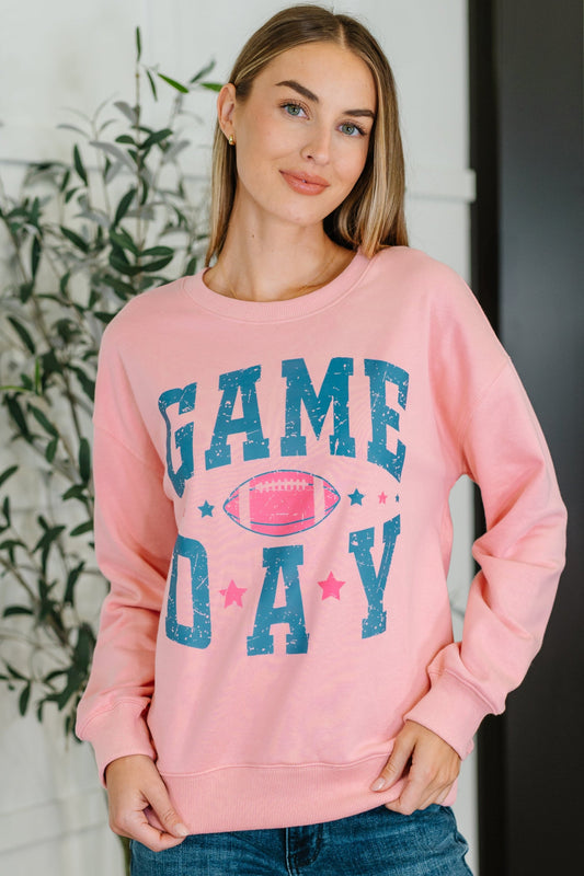 Pink 'Game Day' sweatshirt with a football graphic.