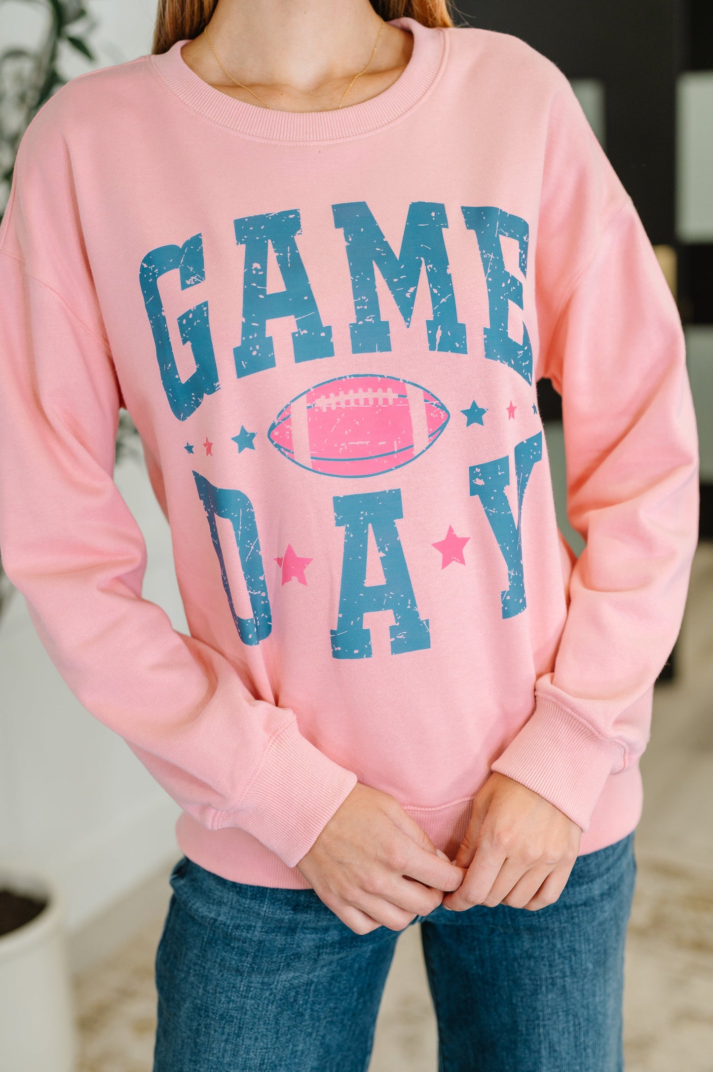 Pink 'Game Day' sweatshirt with a football graphic.