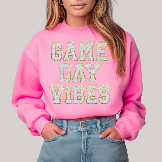 Pink sweatshirt with 'GAME DAY VIBES' text 