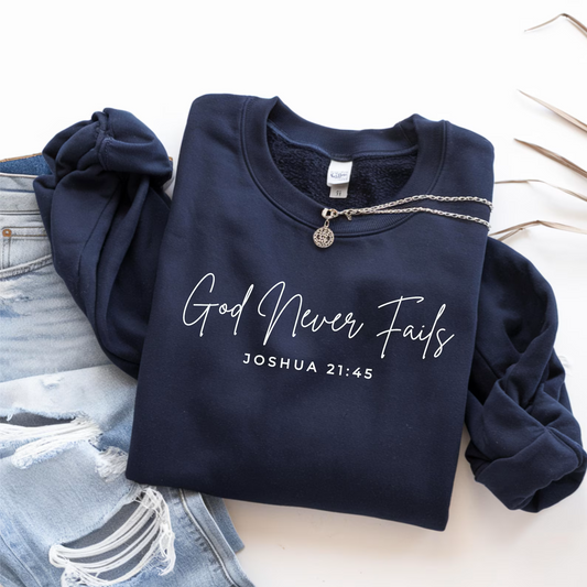 Navy blue sweatshirt with 'God Never Fails' text on a light background