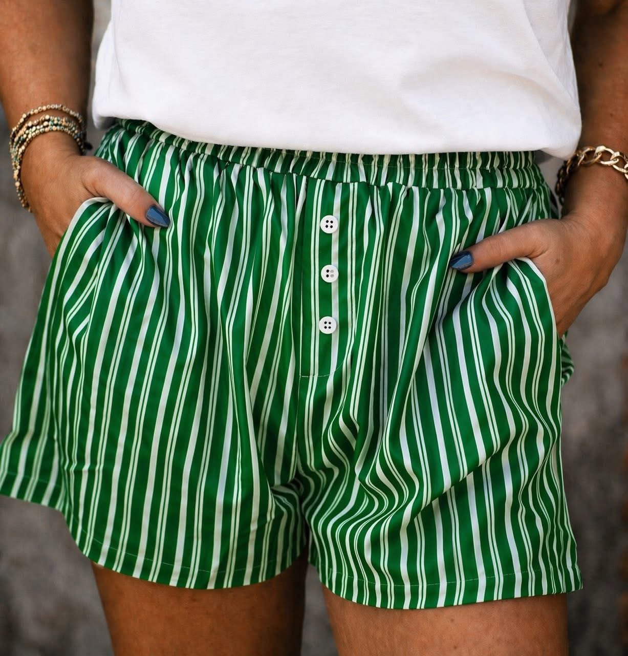 Women’s green striped casual shorts with button front detail and pockets